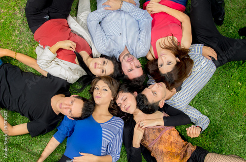 Group of friends laying down in park photo