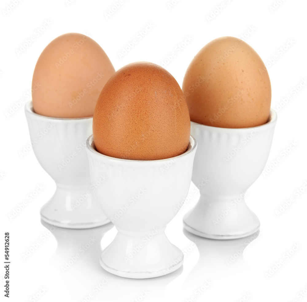Whole boiled eggs in eggs cups isolated on white Whole boiled eggs in eggs cups isolated on white
