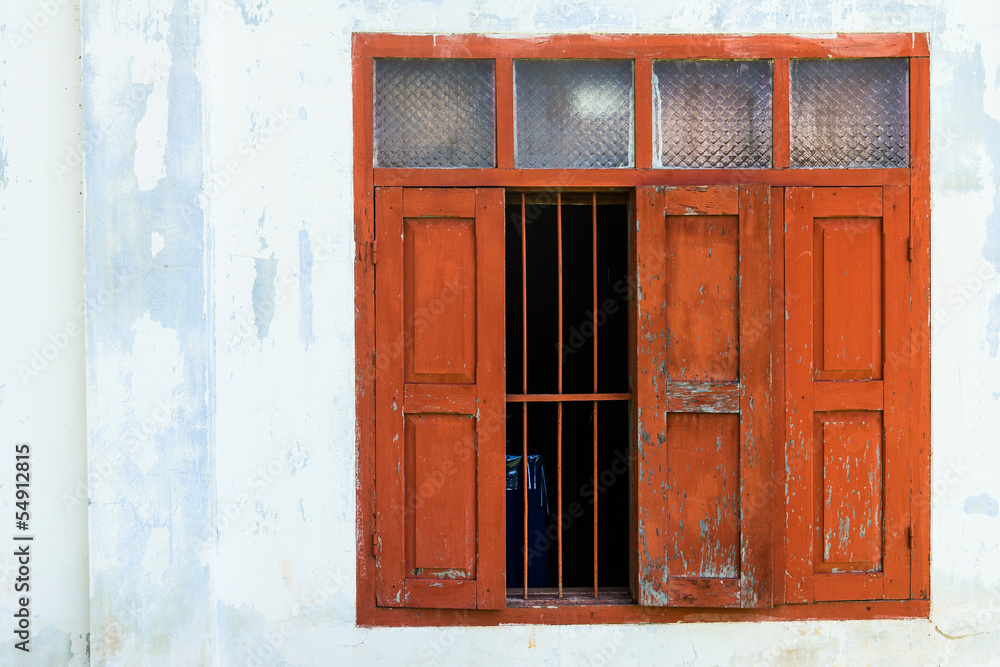 Red wooden window with white wall