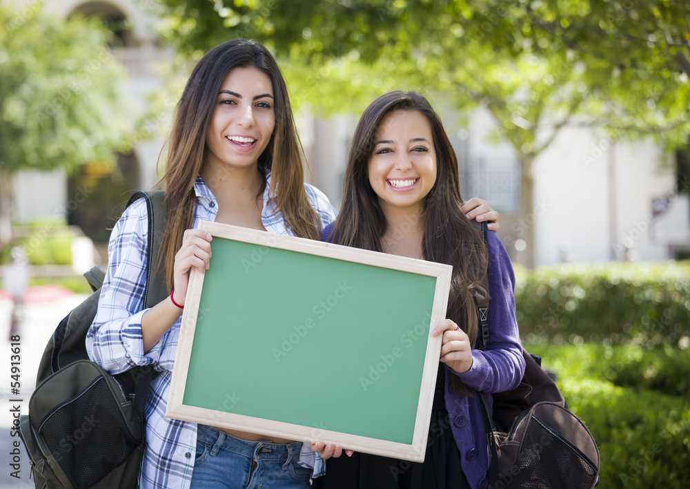 Fototapeta premium Mixed Race Female Students Holding Blank Chalkboard
