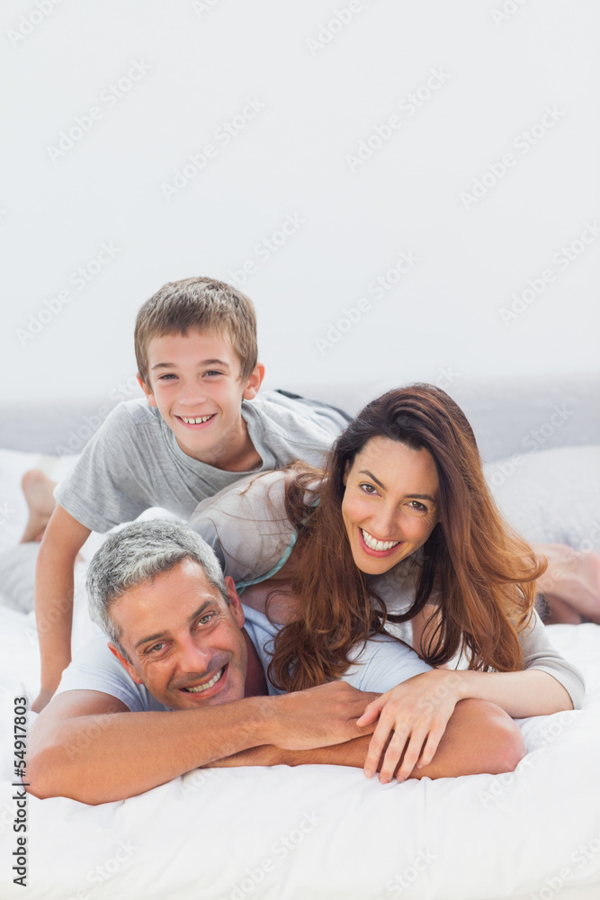 Parents with their son lying on bed