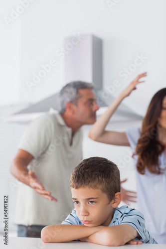Couple having dispute in front of their upset son