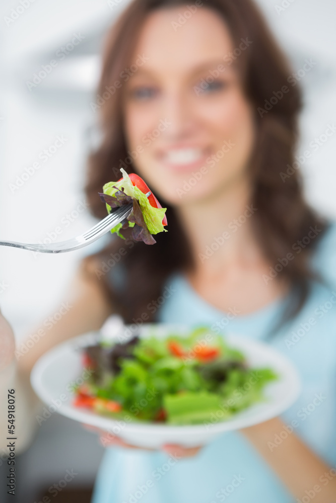 Healthy brunette offering salad Healthy brunette offering salad
