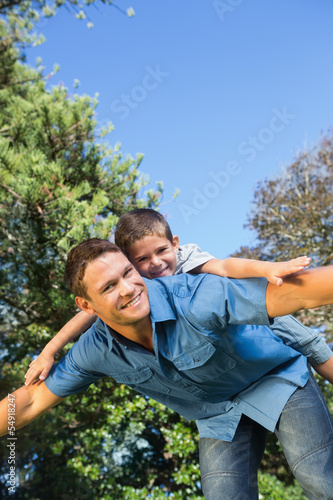 Son lying on his fathers back