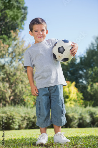 Young boy holding football © WavebreakmediaMicro
