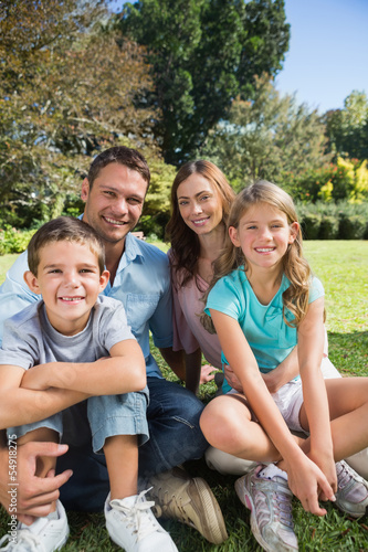 Cheerful family relaxing outside