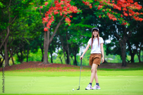 Smiling asian woman golfer