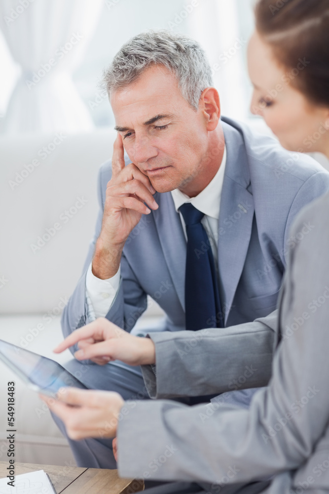 Smiling businessman working with his colleague Smiling businessman working with his colleague