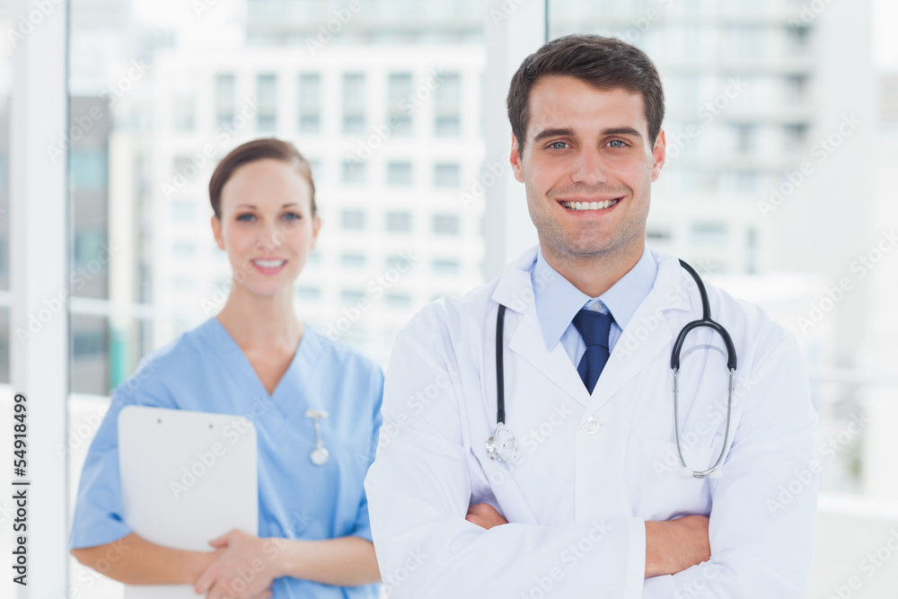 Smiling surgeon and doctor posing together