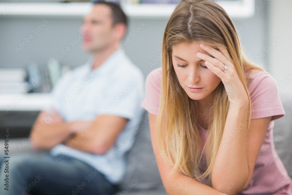 Upset woman thinking on couch after fight with husband Upset woman thinking on couch after fight with husband