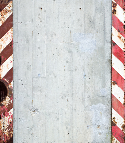 concrete wall with red and white warning stripes