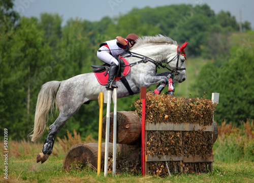 Obraz na płótnie Three day event rider taking part in the cross country Phase w salonie