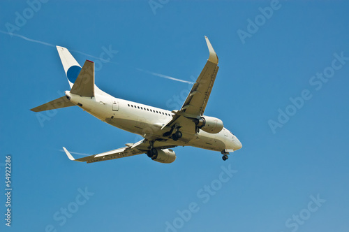 Passenger plane flies in blue sky
