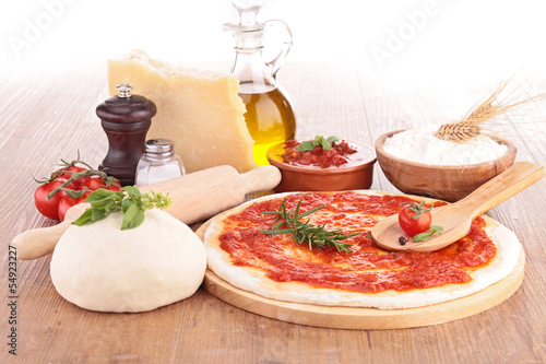 pizza dough with tomato sauce and ingredients