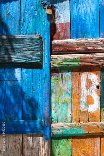 Close-up of a painted door with a lock © piccaya