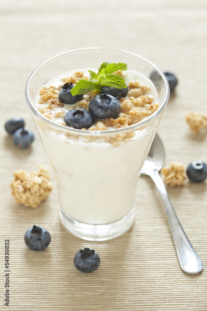 delicious healthy breakfast, yogurt with cereal and blueberries delicious healthy breakfast, yogurt with cereal and blueberries