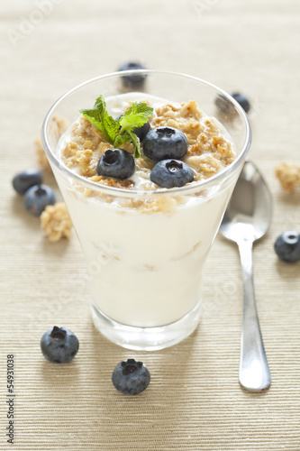 delicious healthy breakfast, yogurt with cereal and blueberries