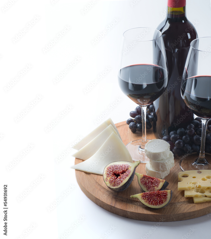 Two glasses of red wine, goat cheese and fig