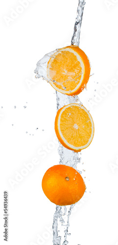 Fresh oranges falling in water splash, isolated on white backgro