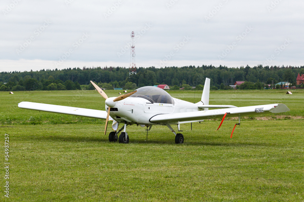 small wite airplane on the ground small wite airplane on the ground