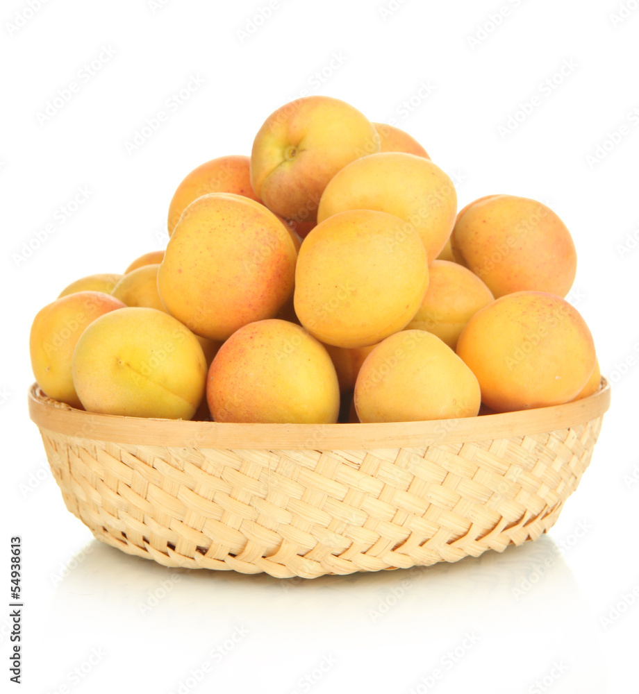 Fresh natural apricot in wicker basket isolated on white Fresh natural apricot in wicker basket isolated on white