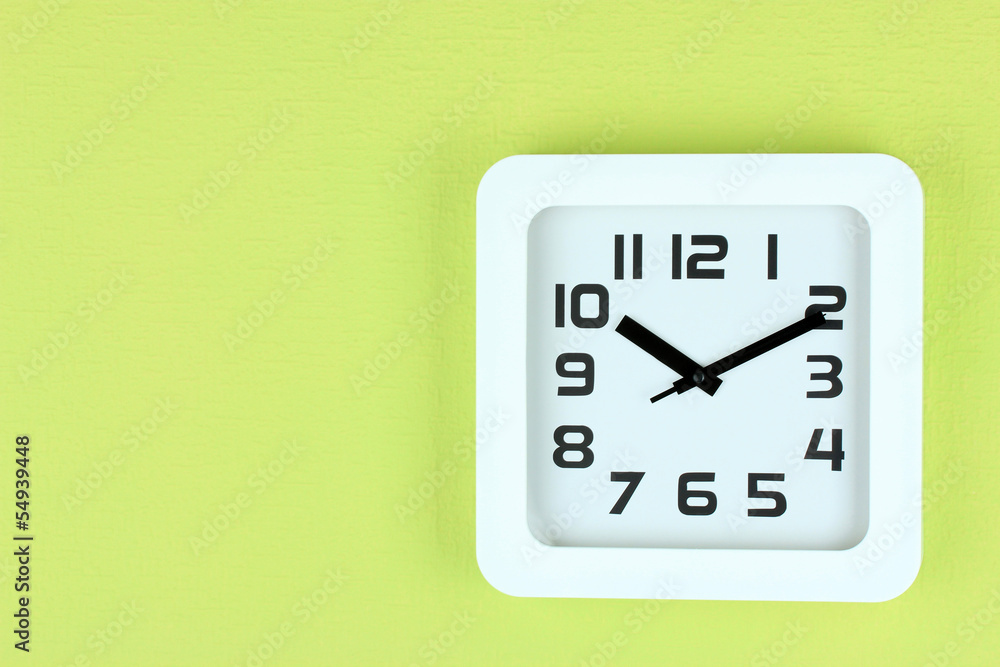 Office clock on color wall background Office clock on color wall background