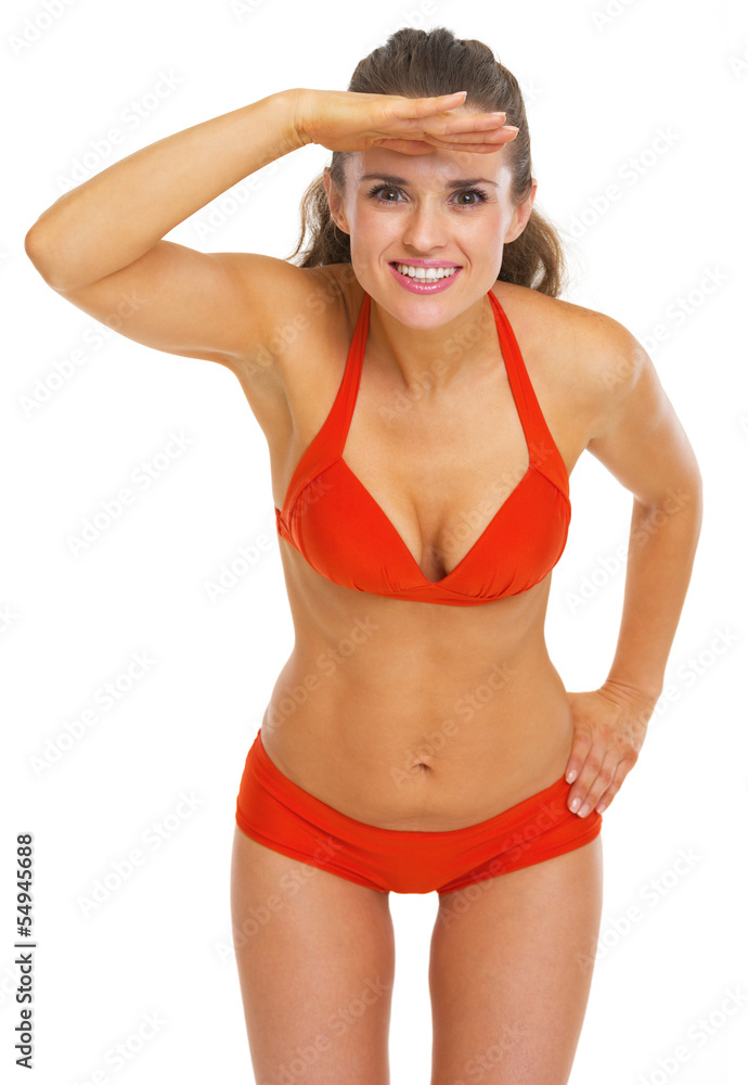Happy young woman in swimsuit looking into distance Happy young woman in swimsuit looking into distance