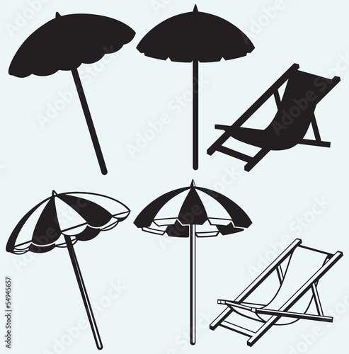 Fototapeta Chair and beach umbrella isolated on blue background