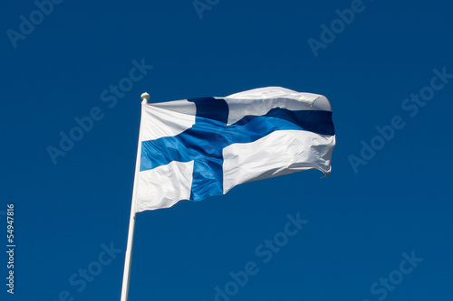 Flag of Finland before blue sky.