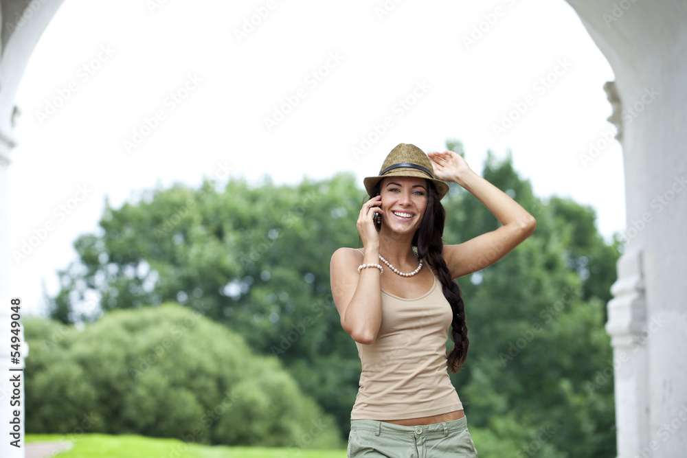 Happy woman talking on cell phone