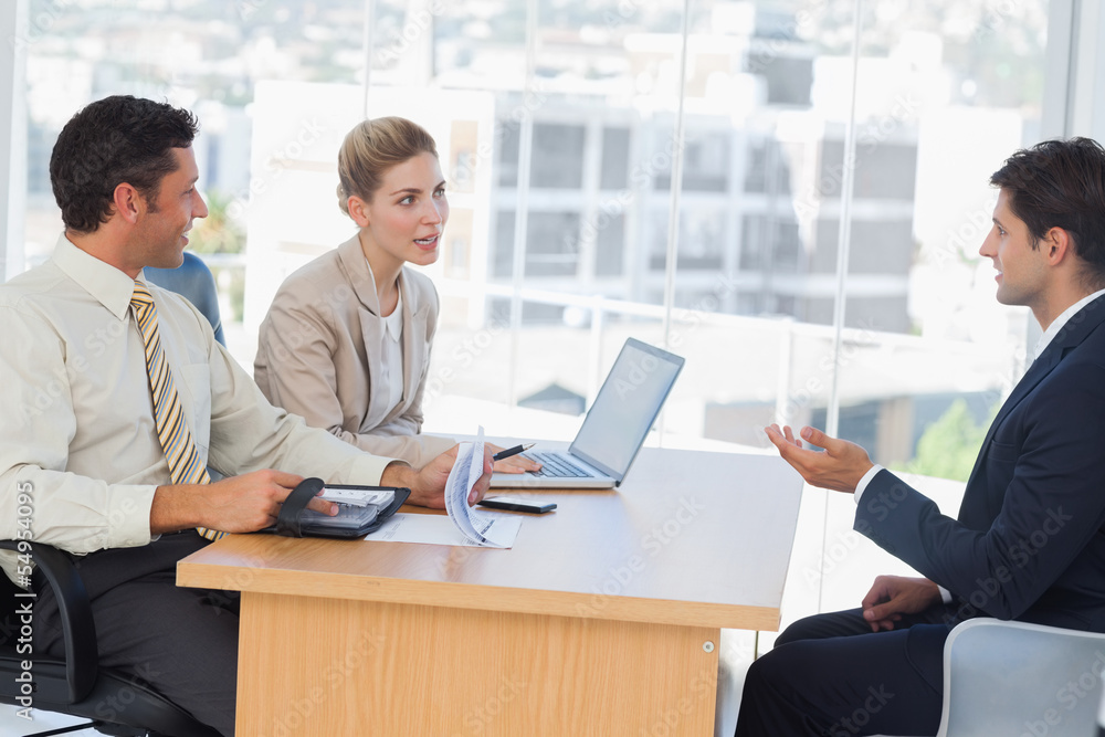 Business people speaking during interview Business people speaking during interview