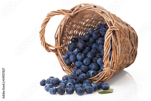 blueberries in wooden basket isolated over white
