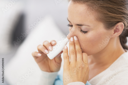 Woman using nasal drops photo