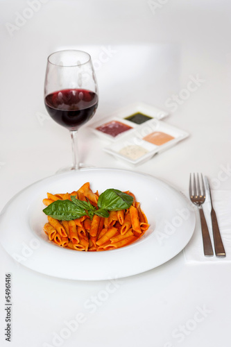 Delicious pasta and red wine served for dinner