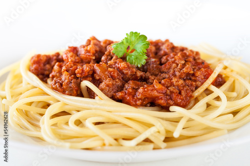 Spaghetti bolognese decorated with coriander leaf