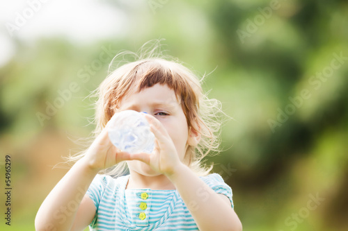   girl drinking from plastic bottle