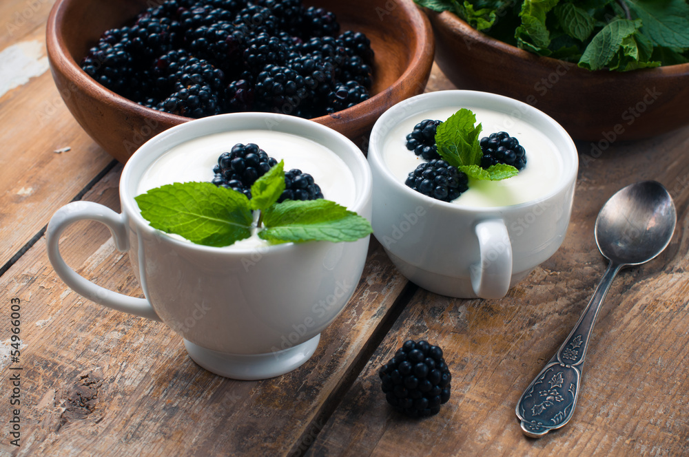 Two cups of creamy yogurt with blackberries Two cups of creamy yogurt with blackberries
