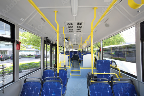 Blue seats inside saloon of empty city bus