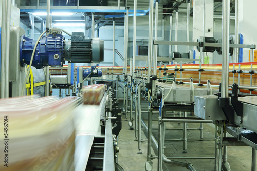 Bottles and cases with bottles go on conveyors