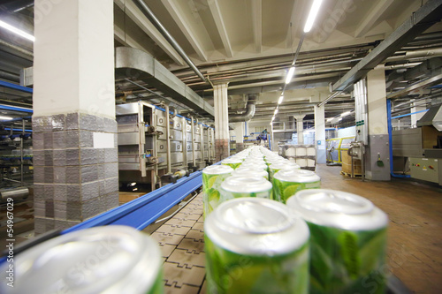 Cans with drink mojito on conveyor photo