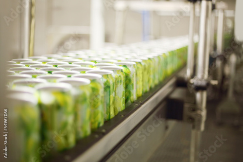 Empty aluminum cans for drinks move on conveyor at large factory