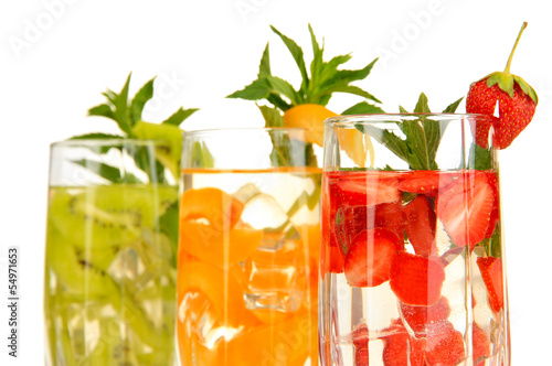 Glasses of fruit drinks with ice cubes isolated on white