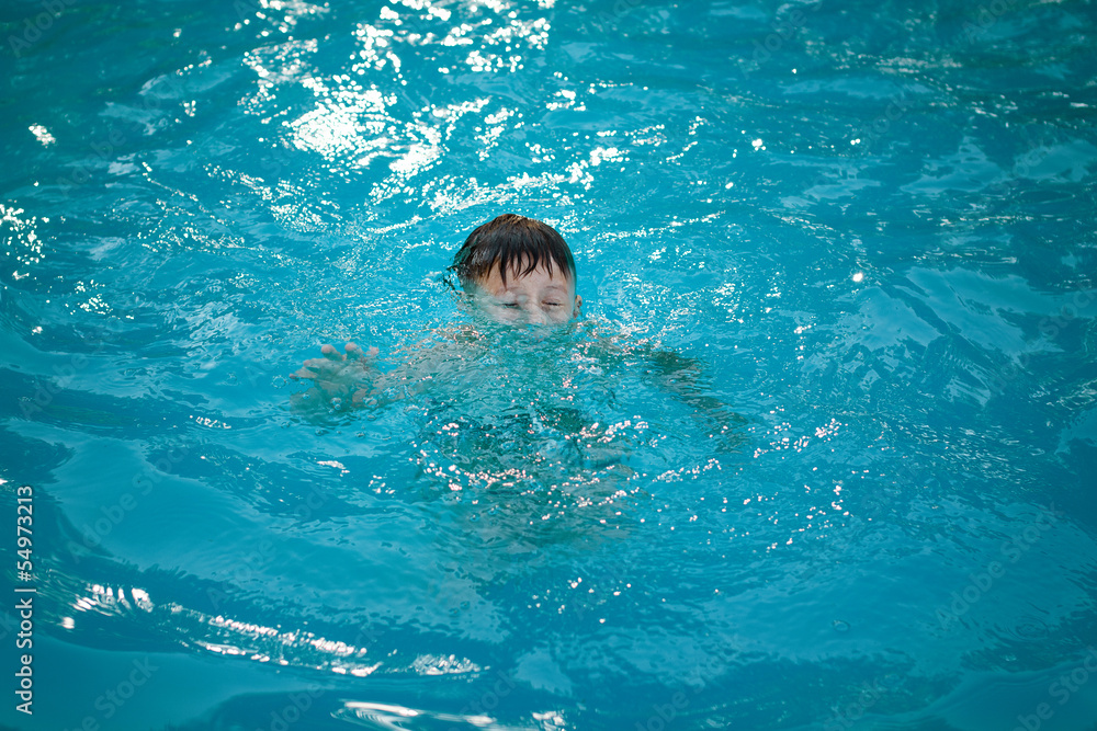 Young boy drowning in the pool