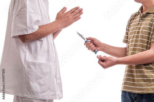 Close up of man, holding a knife in his hands, threatening a doc