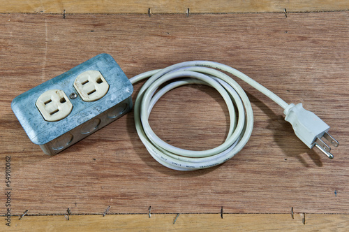 Old damage Extension cord on wood background
