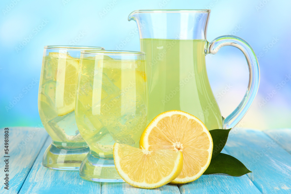Delicious lemonade on table on blue background Delicious lemonade on table on blue background