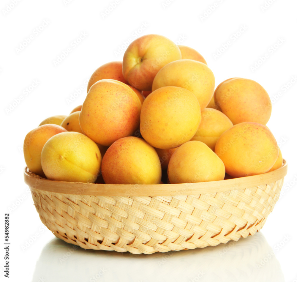 Fresh natural apricot in wicker basket isolated on white Fresh natural apricot in wicker basket isolated on white