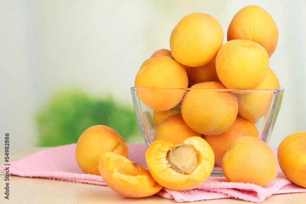 Fresh natural apricot in bowl on table in kitchen