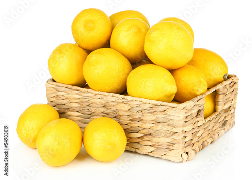 Ripe lemons in wicker basket isolated on white