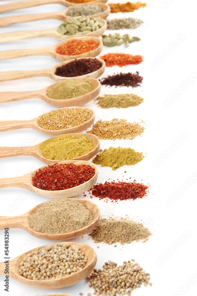 Assortment of spices in wooden spoons, isolated on white Assortment of spices in wooden spoons, isolated on white